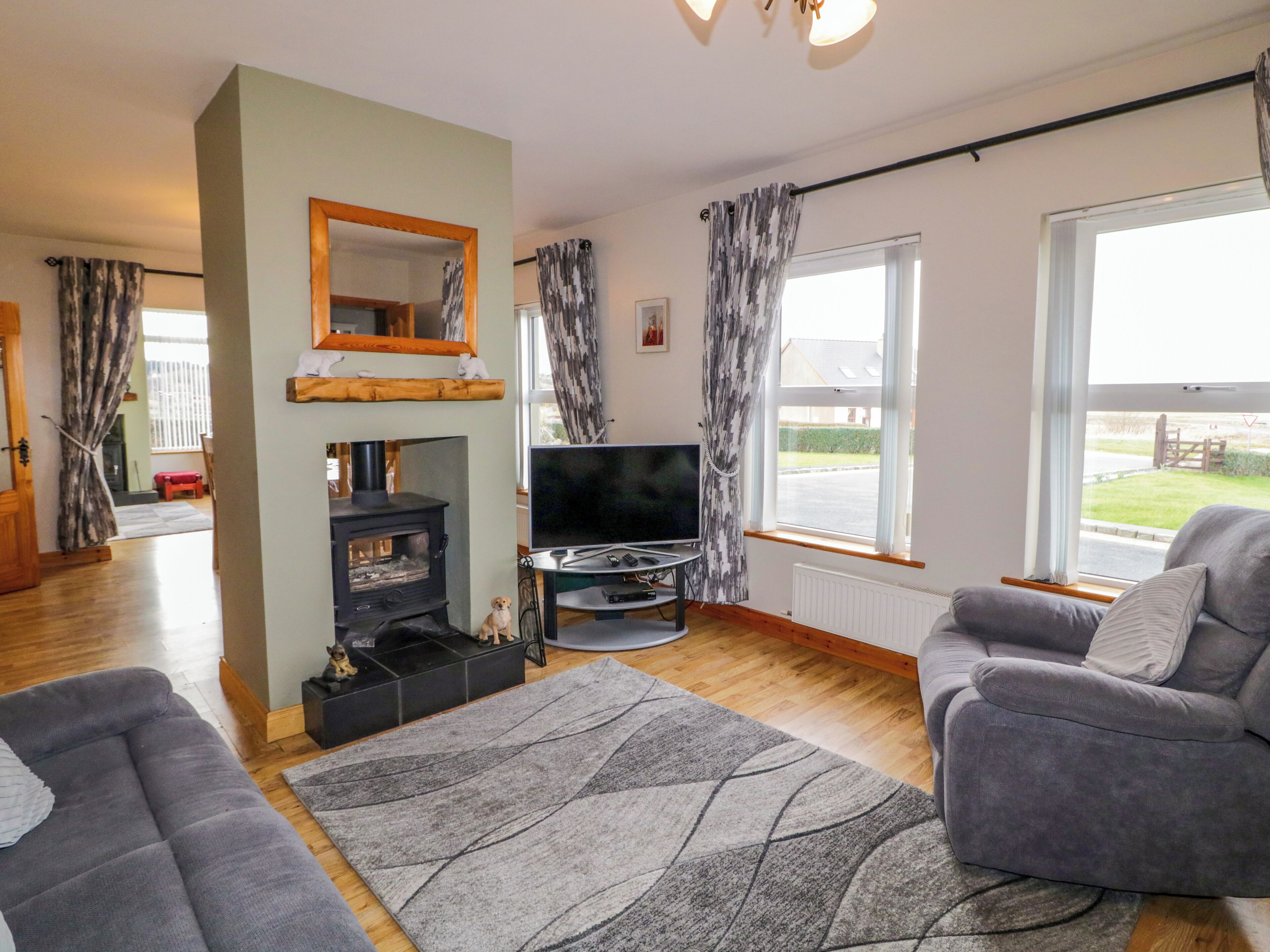 A living room with a fireplace, a television, and a sofa.