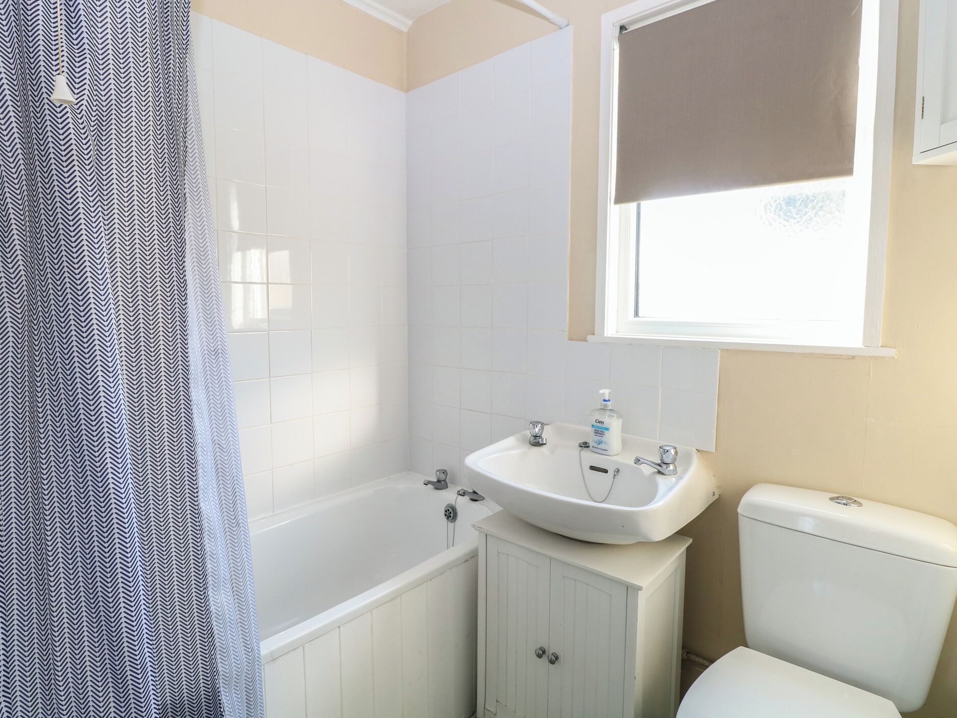 A bathroom with a bathtub, a sink, and a toilet.