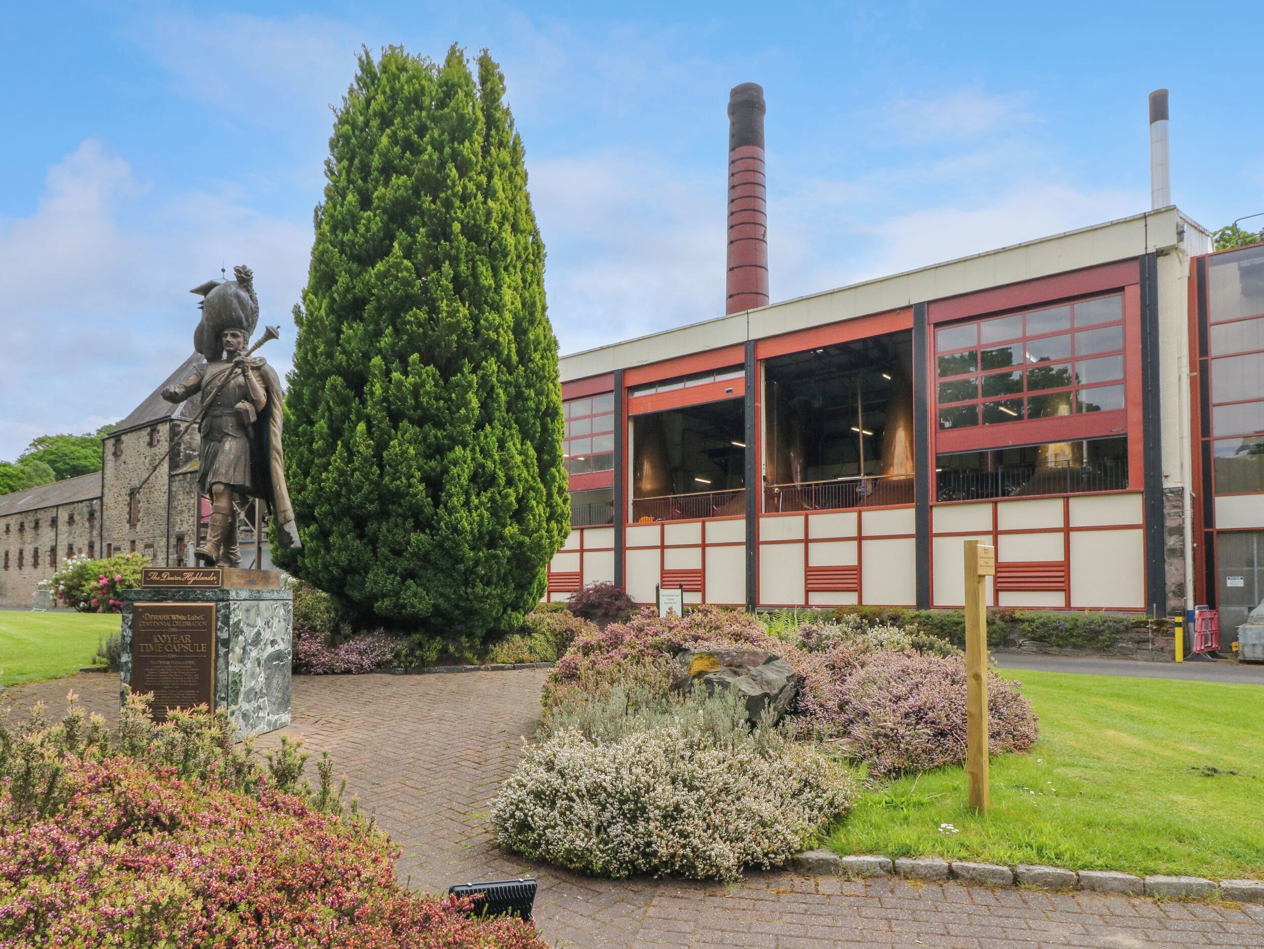 A building with large windows and a statue in front.