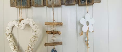 A wall-mounted decoration with a series of wooden houses and various hanging ornaments.