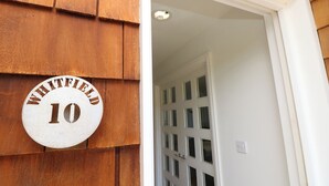 A wooden exterior with a white door and a sign reading "WHITFIELD 10". - Whitfield P10 (Yarmouth)