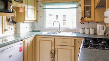 Fridge, electric kettle, cookware/dishes/utensils