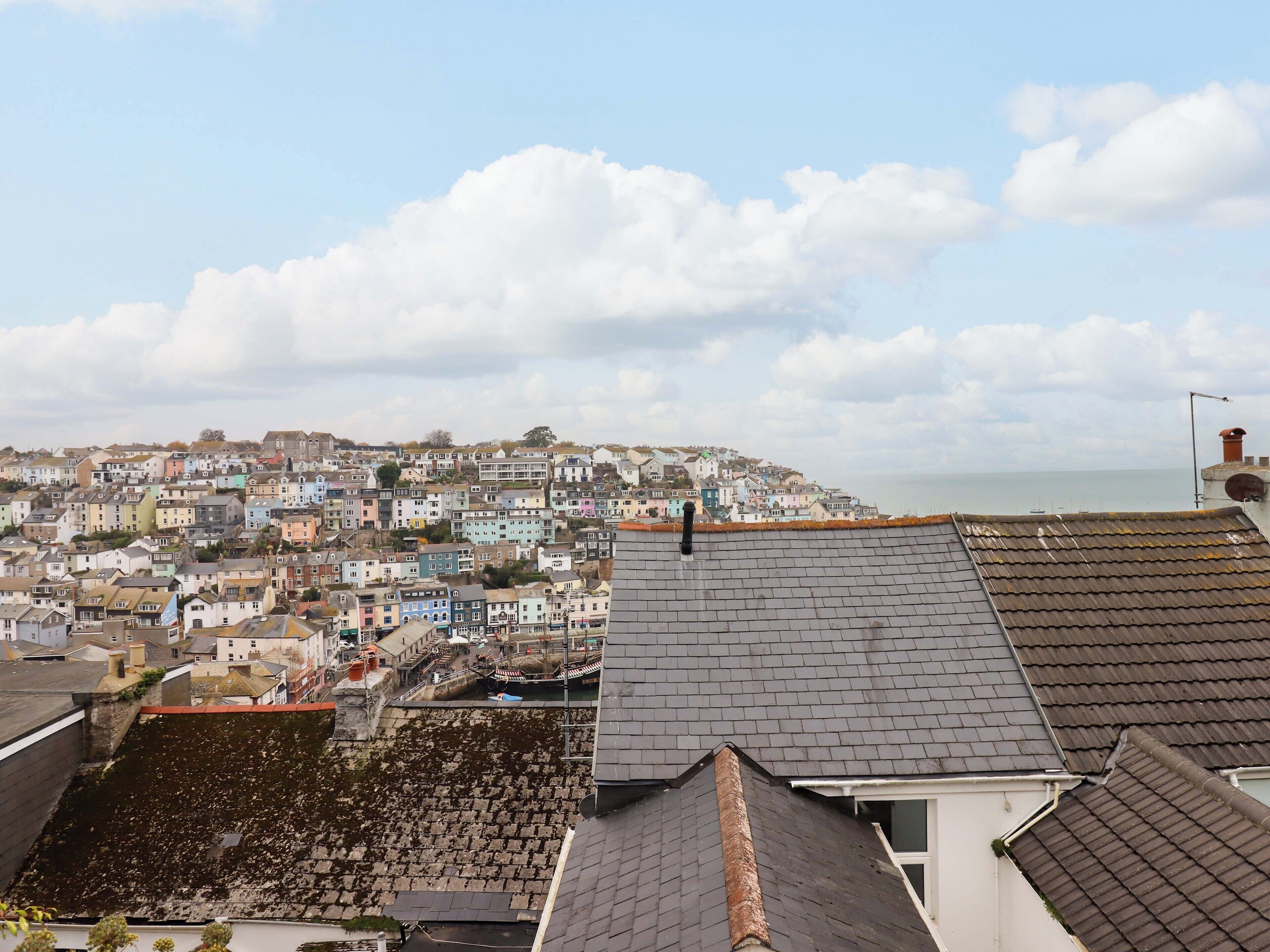 A coastal town with colorful buildings and a view of the sea.