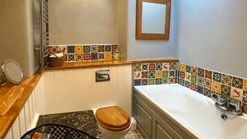 Un baño con bañera, inodoro y lavamanos.