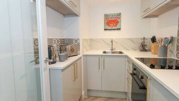 Fridge, electric kettle, toaster, cookware/dishes/utensils