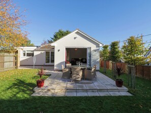 A house with a patio area, a garage, and a fenced backyard. - Farmer's Rest (Ely)