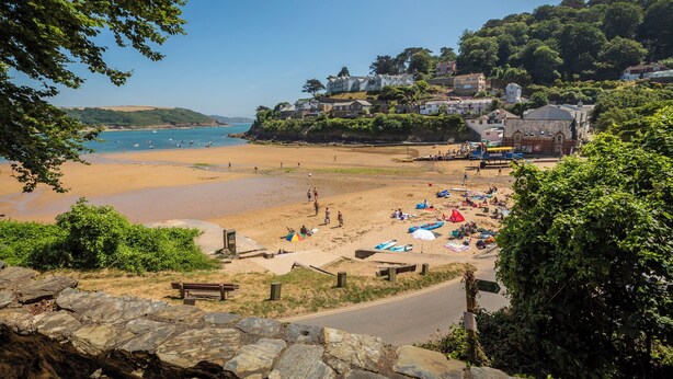 A beach with houses on a hillside, a sandy beach, and a clear blue sky. - 22 Bolt Head (Salcombe)