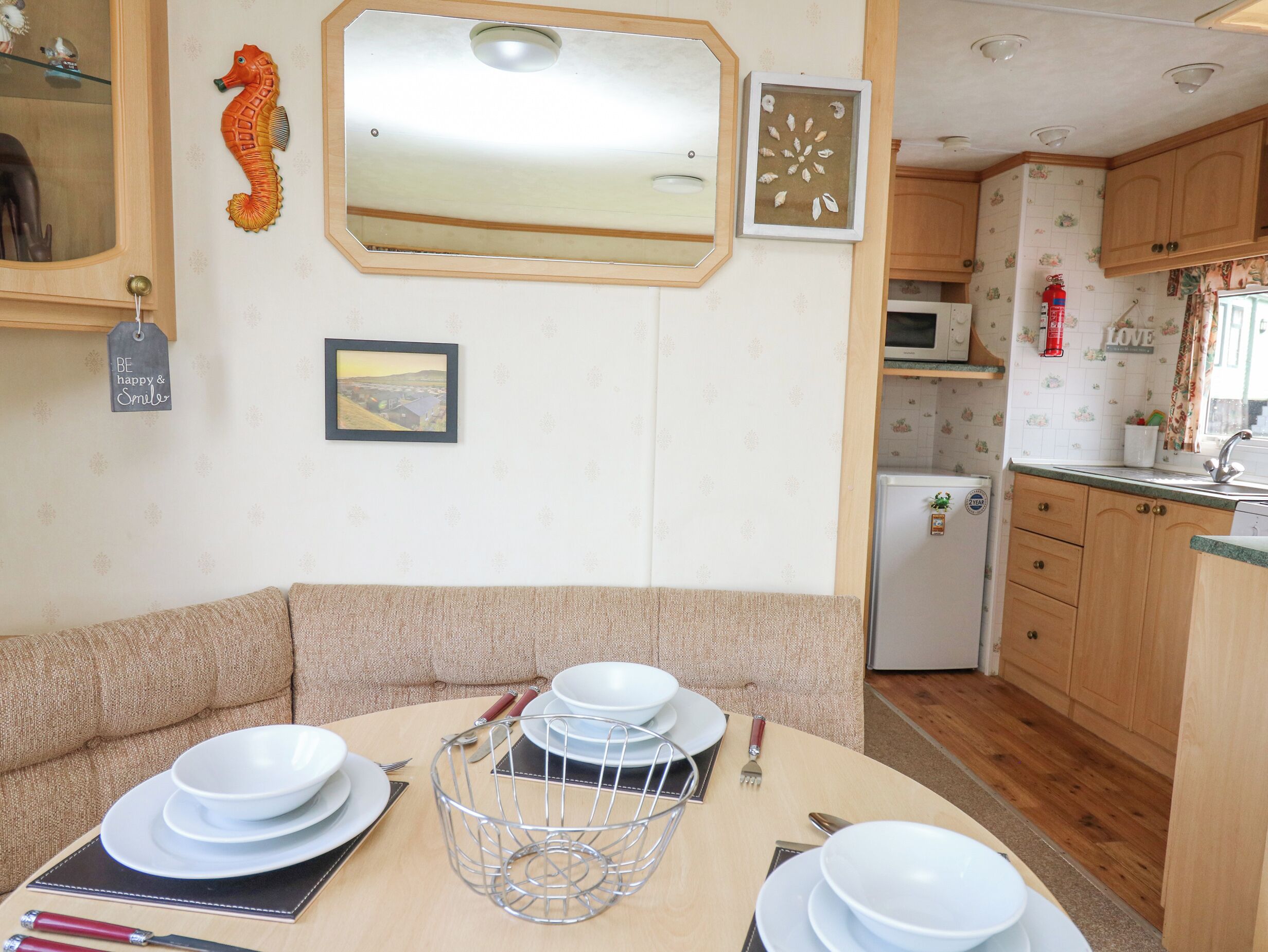 Une cuisine chaleureuse avec des meubles en bois, un four à micro-ondes et un réfrigérateur.
