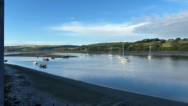 A calm river with boats and a sandy beach. - Rushfield (Cardigan)