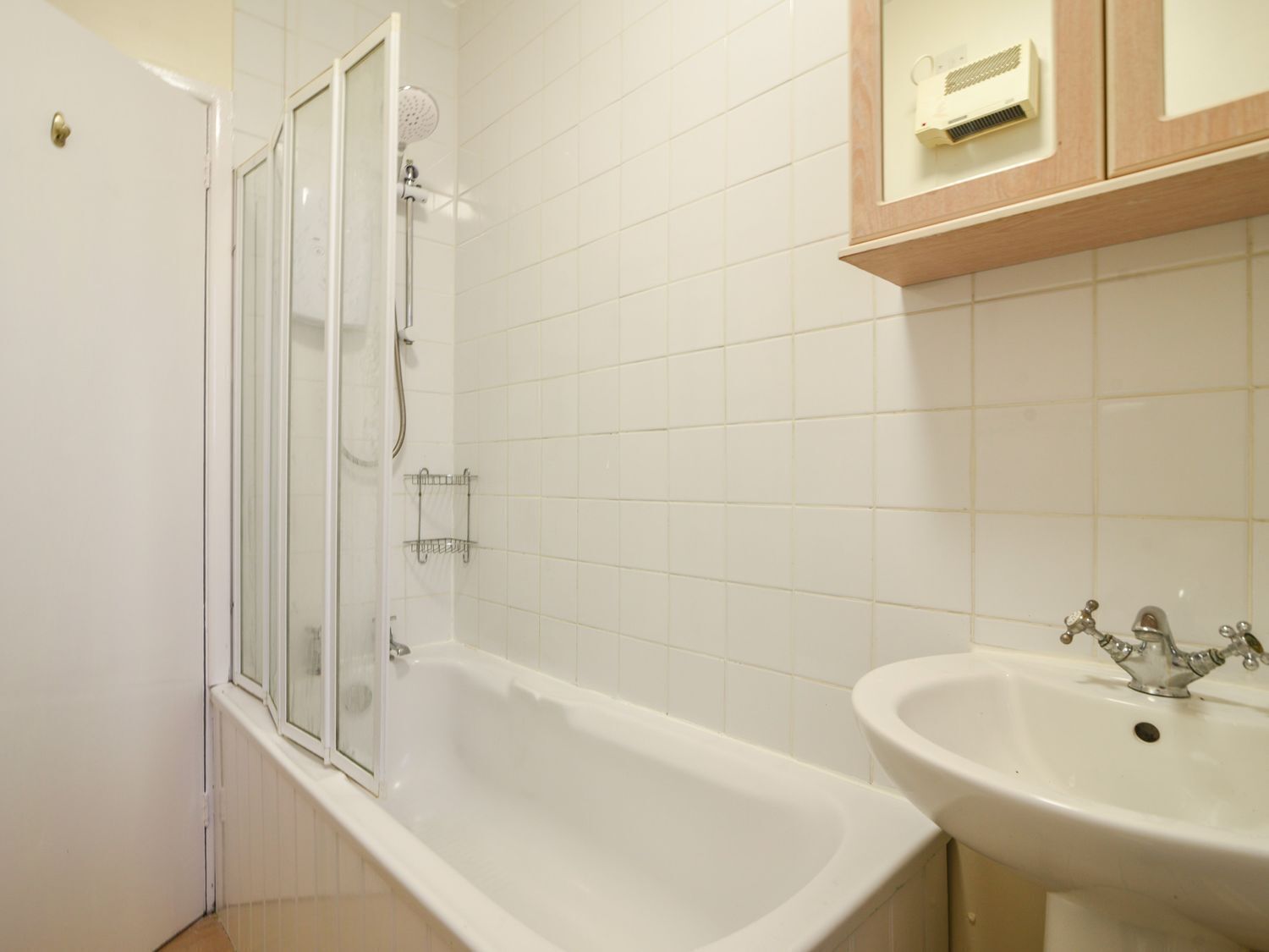 A bathroom with a bathtub, a shower, and a sink.