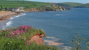 A coastal landscape with a beach, houses, and hills. - 12 Thurlestone Rock (Kingsbridge)
