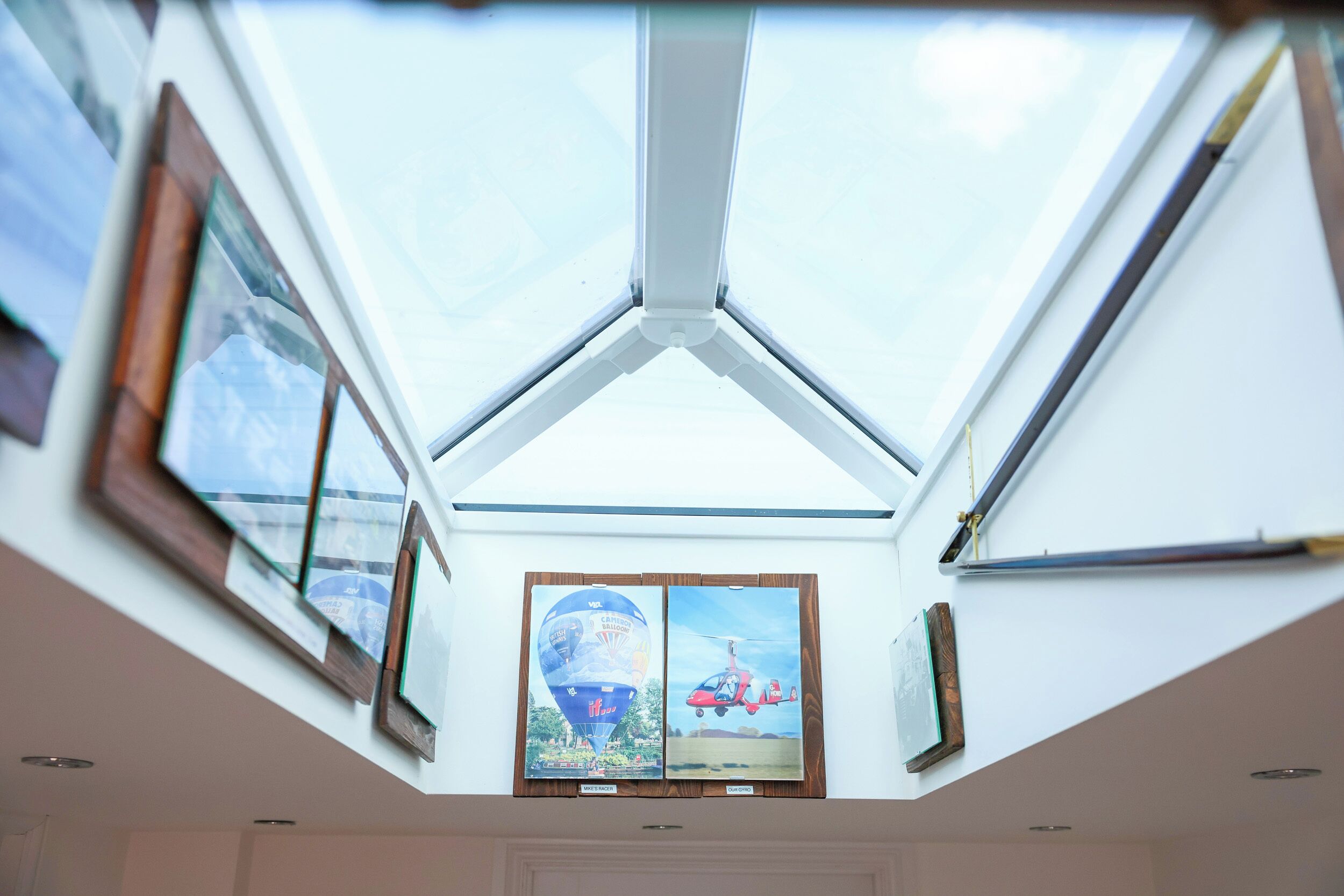 A skylight with framed pictures of a hot air balloon and a helicopter.
