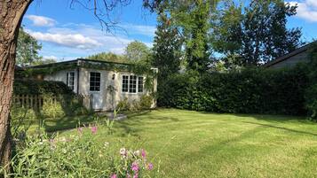 A house with a well-maintained lawn and a wooden fence.