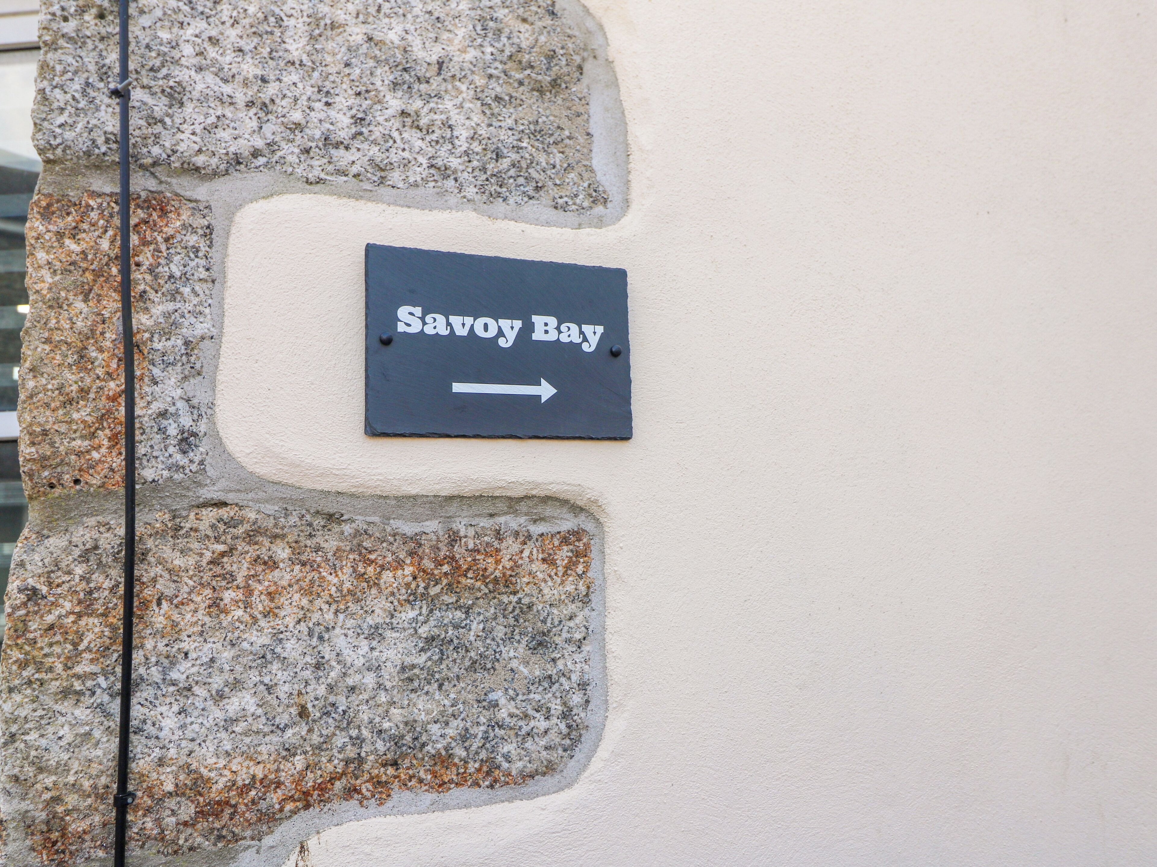 A sign indicating 'Savoy Bay' with an arrow pointing to the right.