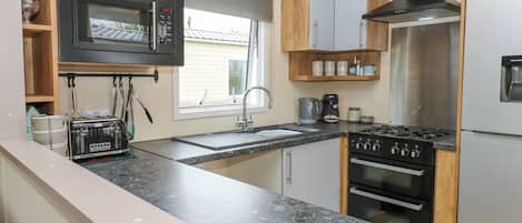 Fridge, electric kettle, cookware/dishes/utensils