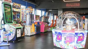 An arcade with various games, including 'Doodle Jump' and 'Big Buck Hunter'.