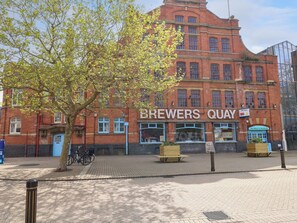 A red brick building with a sign reading "BREWERS QUAY" and a "FOR SALE" sign. - Harbour Retreat (Weymouth)