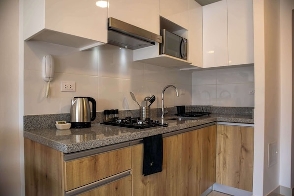 Fridge, microwave, stovetop, coffee/tea maker