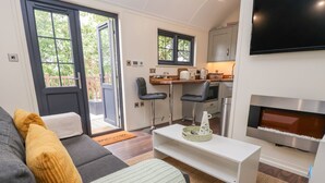 Un salon moderne avec un canapé, une table basse et un téléviseur à écran plat.
