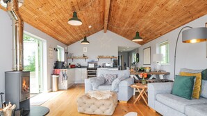 A cozy living room with a fireplace, a sofa, a coffee table, and a rug. - Smugglers (Bodmin)