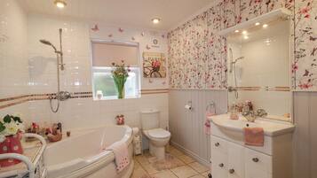 A bathroom with a bathtub, toilet, and sink.