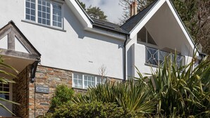A modern building with a stone facade, large windows, and a clear sky. - 17 St Elmo Court (Salcombe)