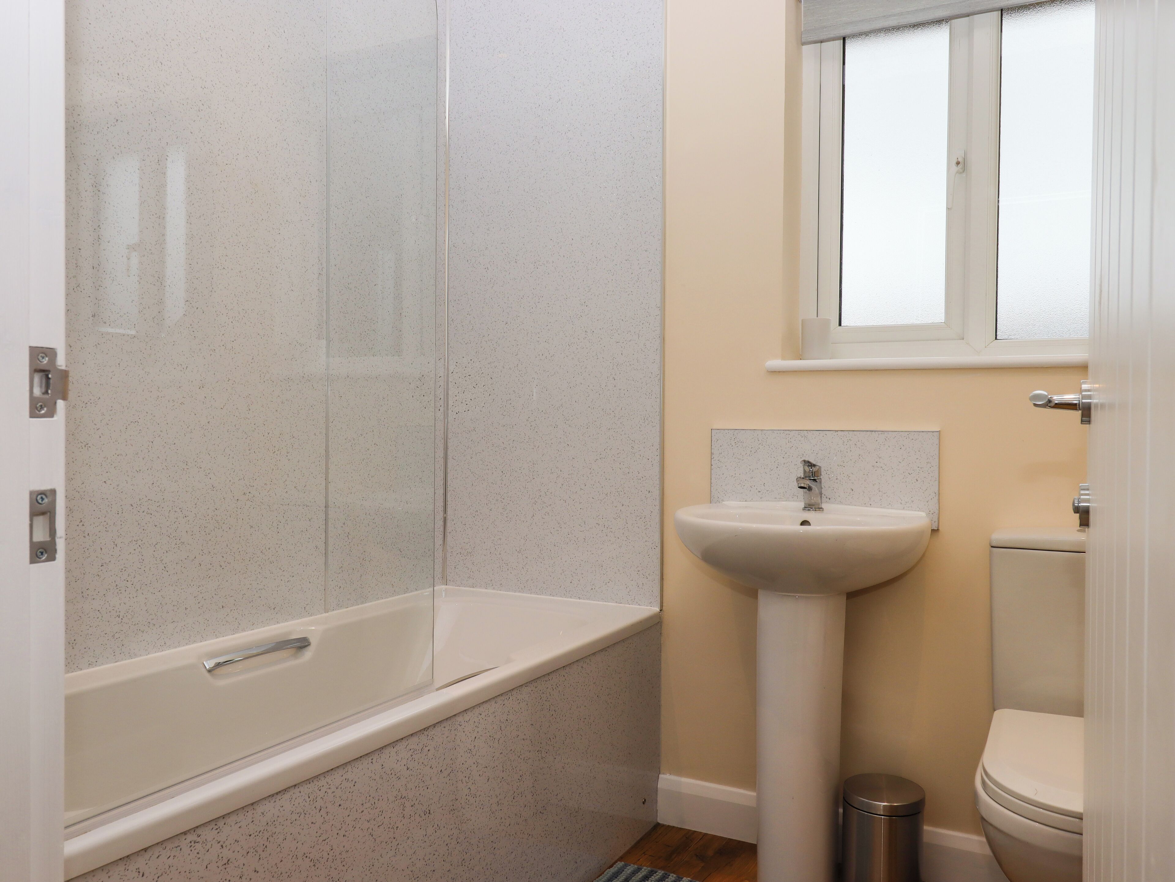 A bathroom with a bathtub, a sink, and a toilet.