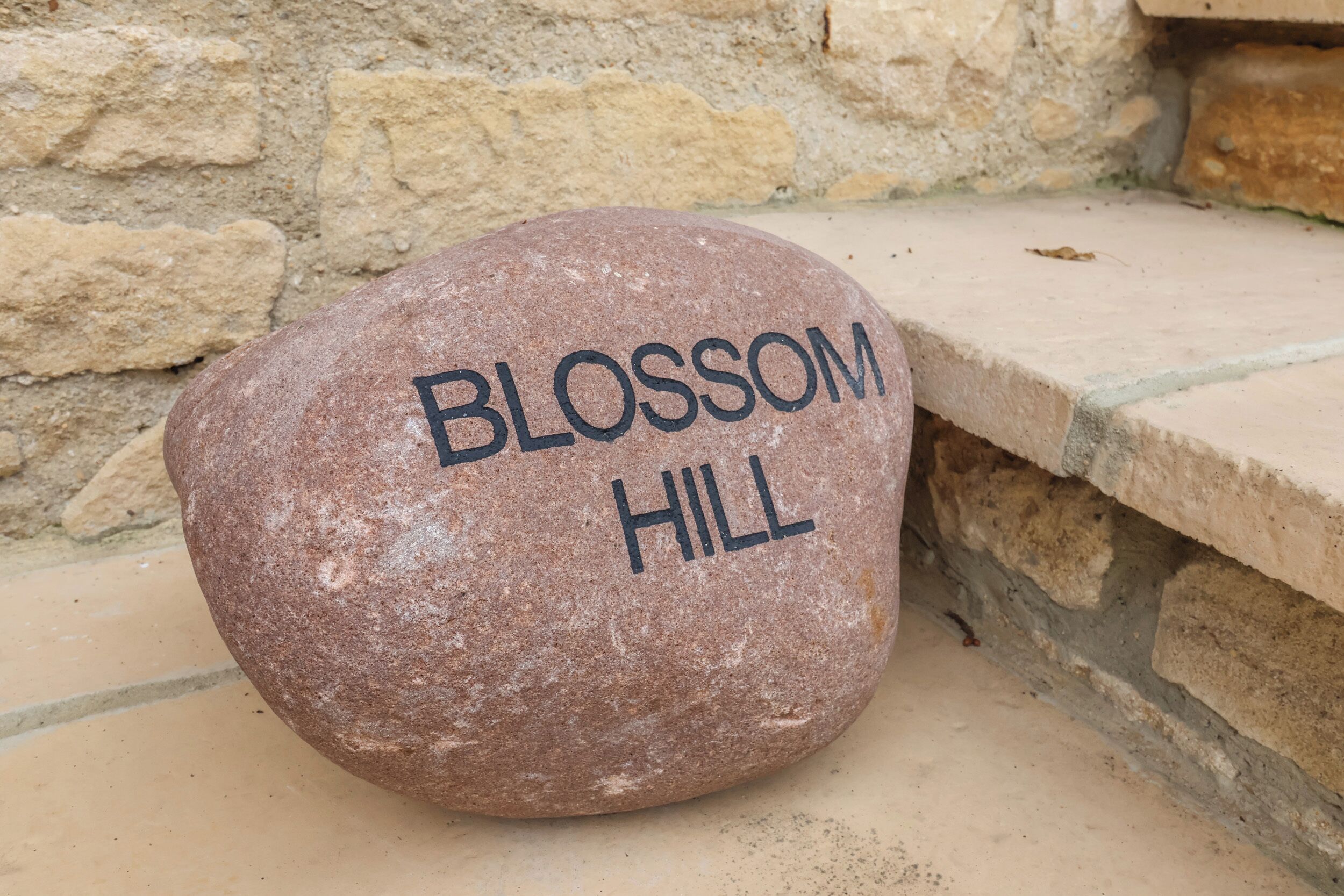 A stone with "BLOSSOM HILL" engraved on it.