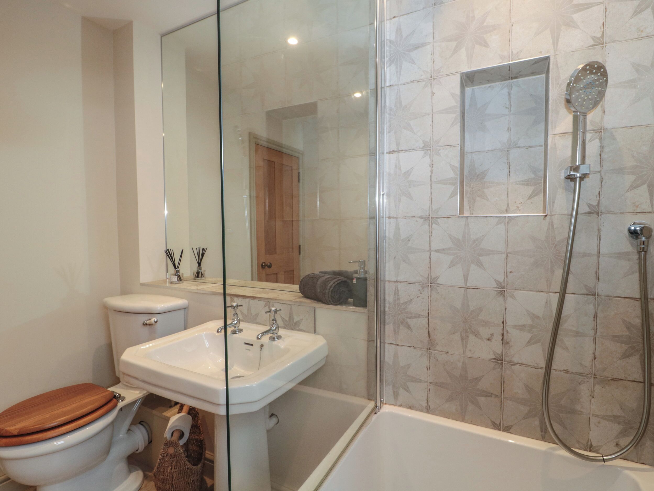 A bathroom with a toilet, sink, and shower.