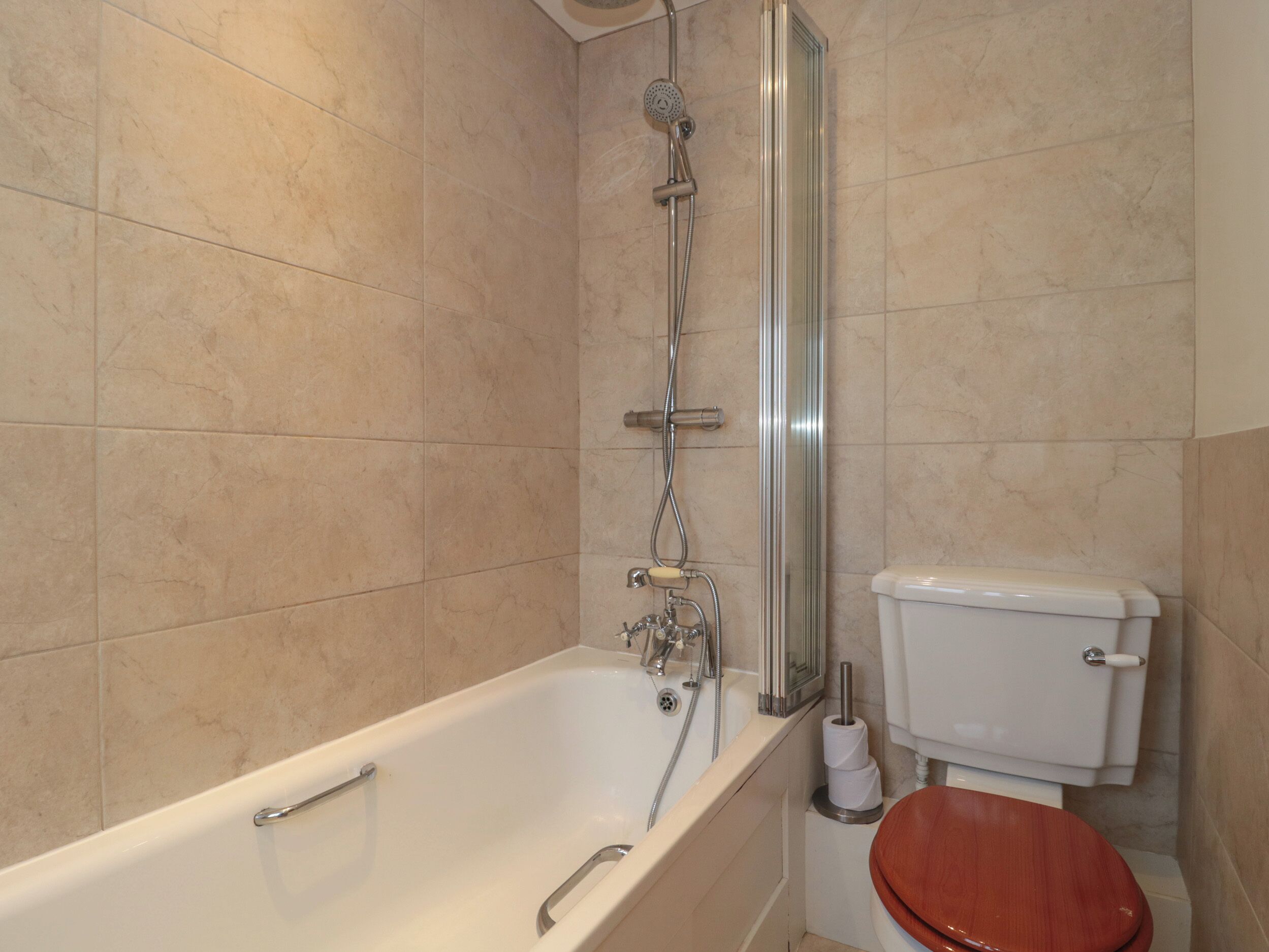 A bathroom with a bathtub, a shower, and a toilet.