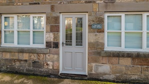 A stone building with a white door and windows, labeled "The Old Post Office." - The Old Post Office (Pickering)