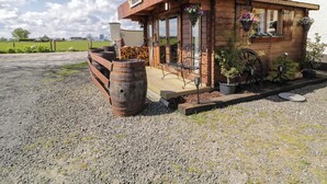 A rustic wooden building with a sign reading "Roches de France." - Rocky Ridge Cabin (Limavady)