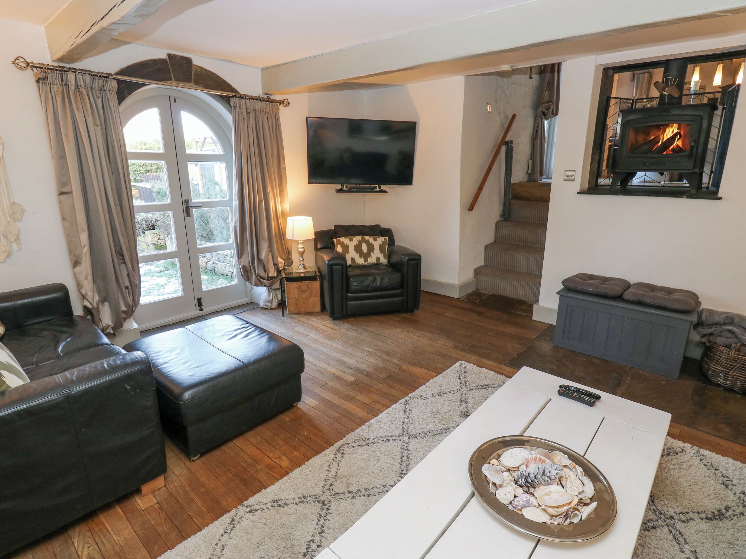 A cozy living room with a fireplace, a television, and a comfortable seating area.