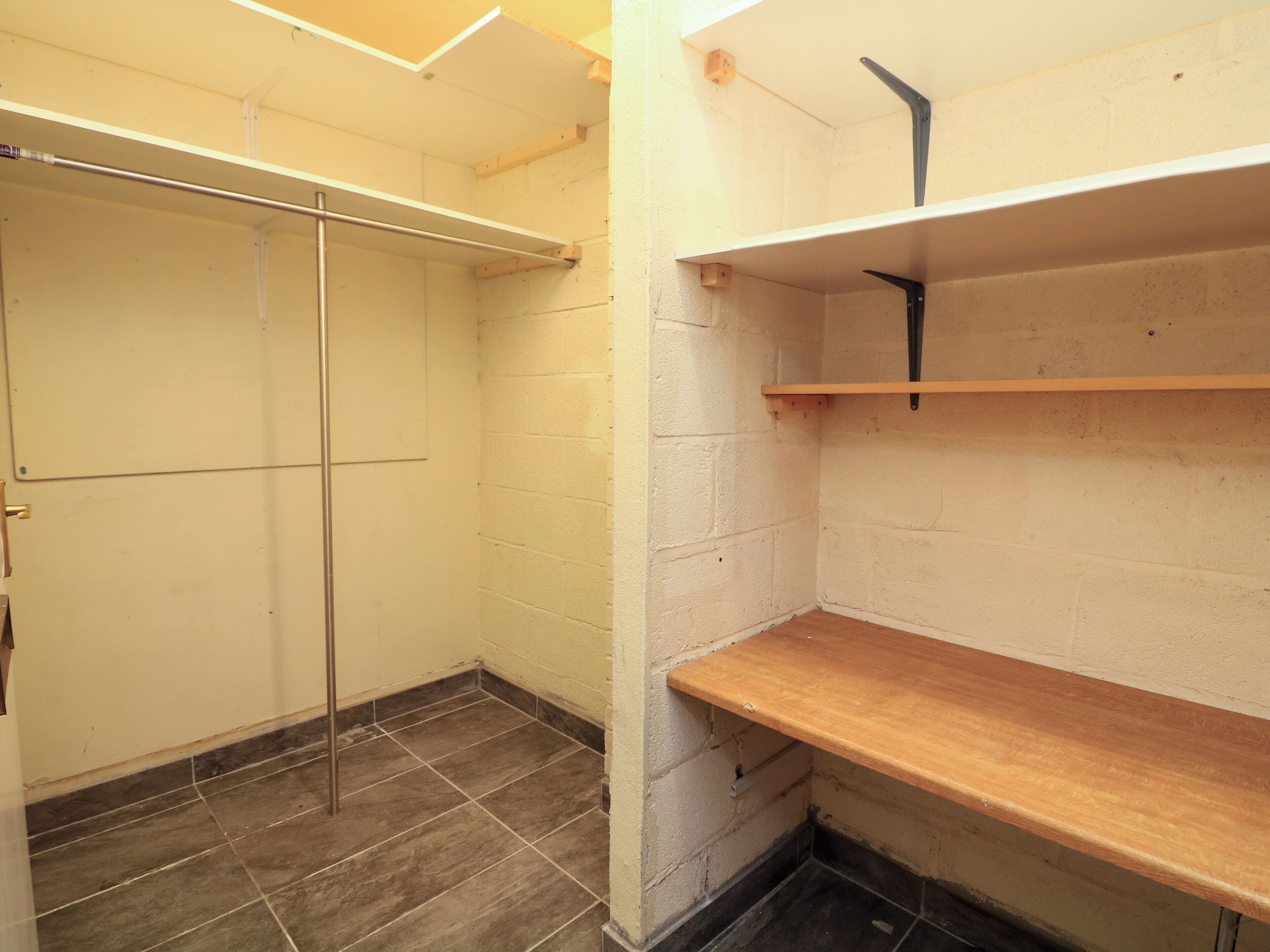 A small, enclosed bathroom with a shower, a toilet, and a sink.