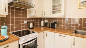 A kitchen with a stove, oven, and a toaster. There is a window above the counter. - Sunnyhaven (Dartmouth)