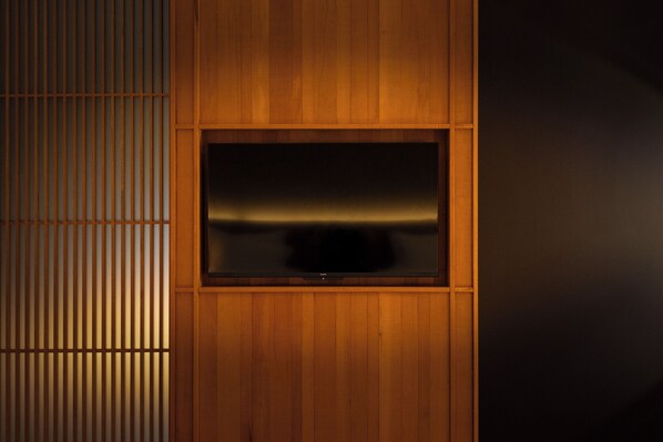 A wooden panel wall with a flat-screen TV mounted in a recessed section. - Changxi Home (Guangzhou)
