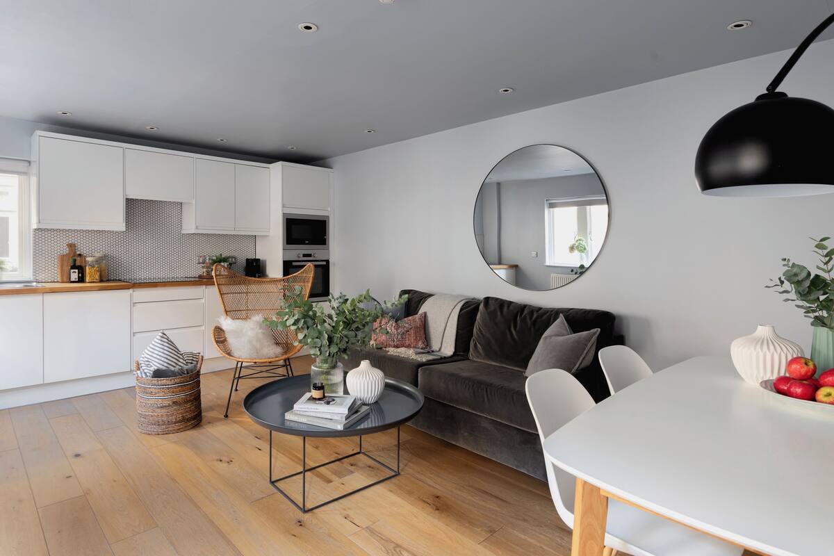 A modern living space with a kitchen, dining area, and seating area.
