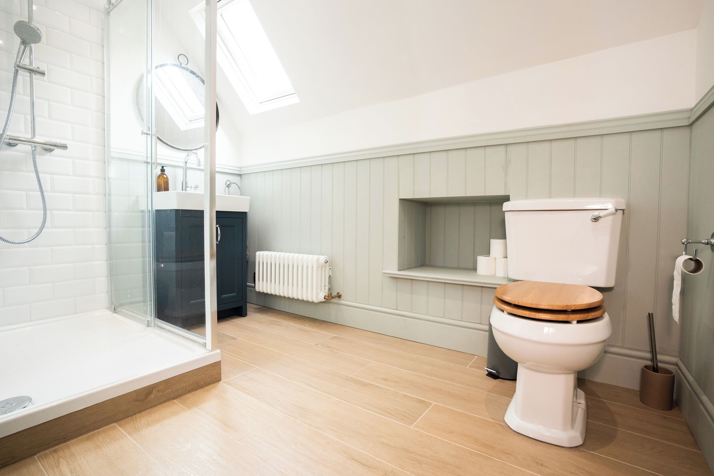 A bathroom with a shower, toilet, and sink.
