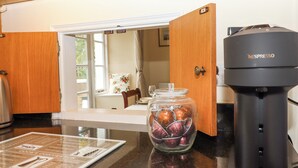 A kitchen with a coffee maker, a jar of cookies, and a recipe card on the counter. - Culver Court Cottage (Crediton)
