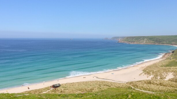 A coastal beach with a clear view of the ocean and a sandy shoreline. - Fifty Degrees North (Penzance)