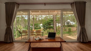 A room with a wooden table, two chairs, and a laptop. - Romdoul Kirirom Resort by EHM (Kampong Seila)