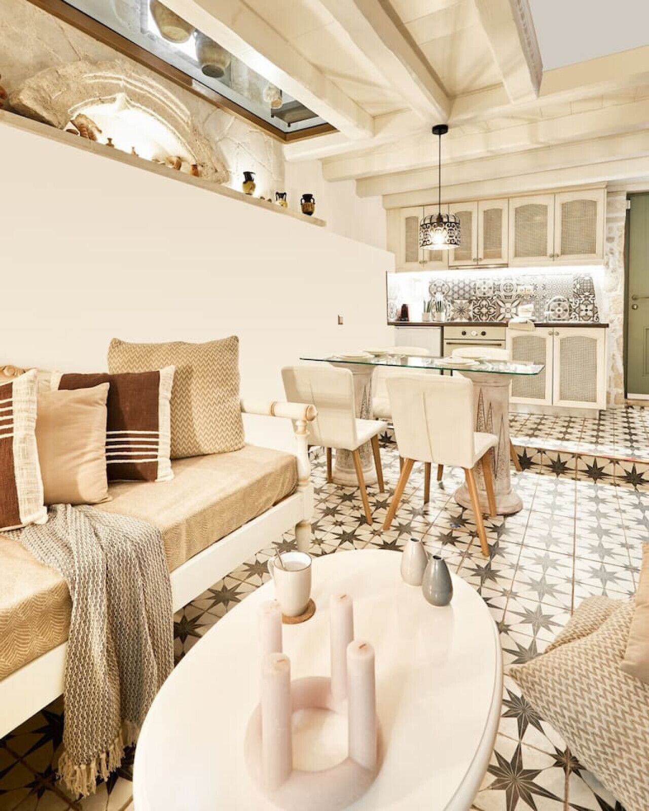 A modern living room with a sofa, dining table, and kitchen in the background.