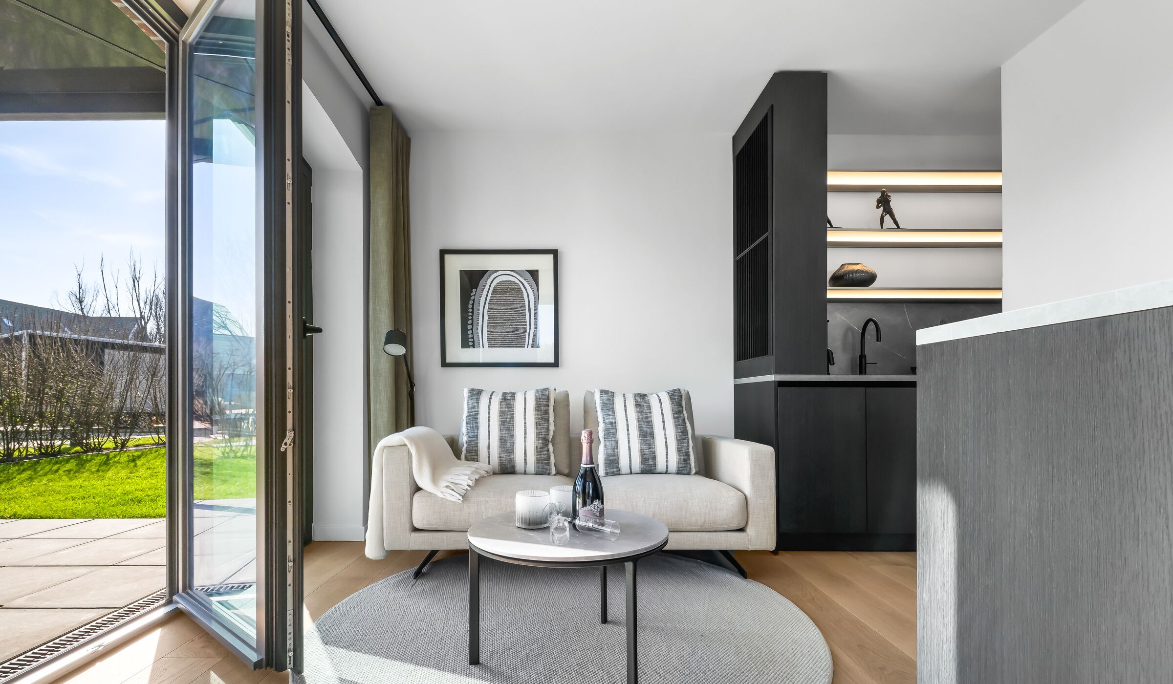 A modern living room with a sofa, a coffee table, and a framed picture on the wall.