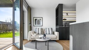 A modern living room with a sofa, a coffee table, and a framed picture on the wall.