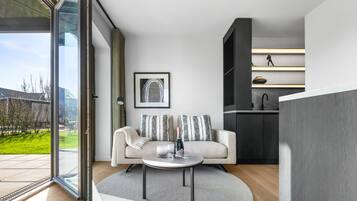 A modern living room with a sofa, a coffee table, and a framed picture on the wall.