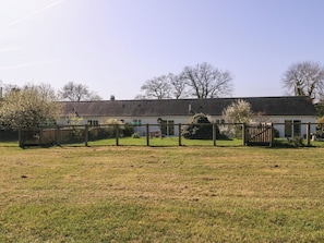 A single-story building with a flat roof, surrounded by a fenced yard. - The Turbles - Swallows Nest (Malvern)