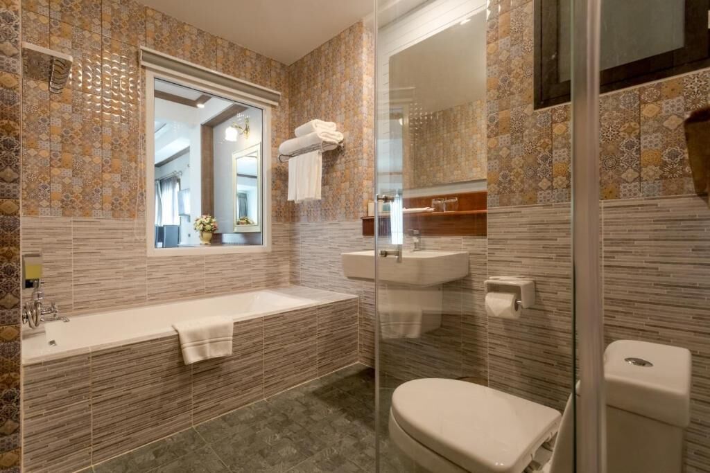 A bathroom with a bathtub, sink, and toilet.