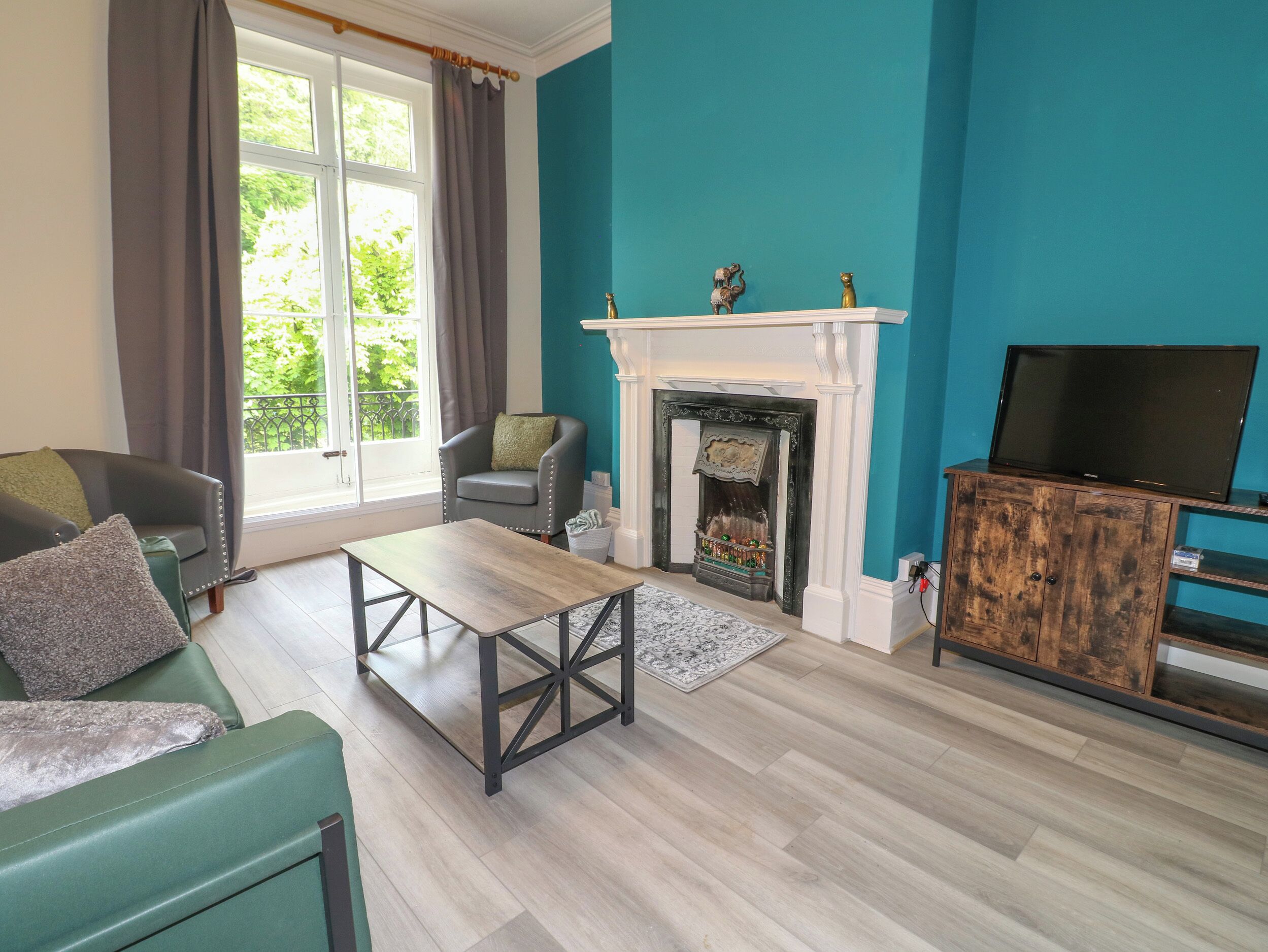 A living room with a fireplace, a television, and a sofa.