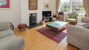 A living room with a fireplace, television, and comfortable seating. - Bron Y Graig (Conwy)