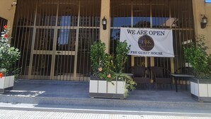 A hotel entrance with a banner reading "WE ARE OPEN FKB GUEST HOUSE". - FBK Guest House  (Addis Ababa)